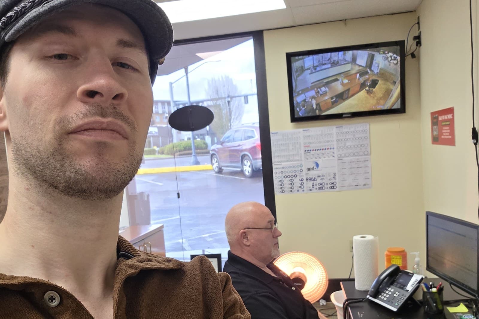 Isaak Hyde in a shop manager's office during a client visit.
